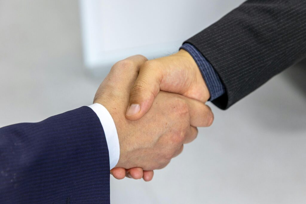 pexels photo 33175650 33175650 Close-up of two businessmen shaking hands, symbolizing agreement and partnership.